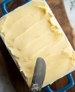 overhead shot of butter in small dish with knife resting on it