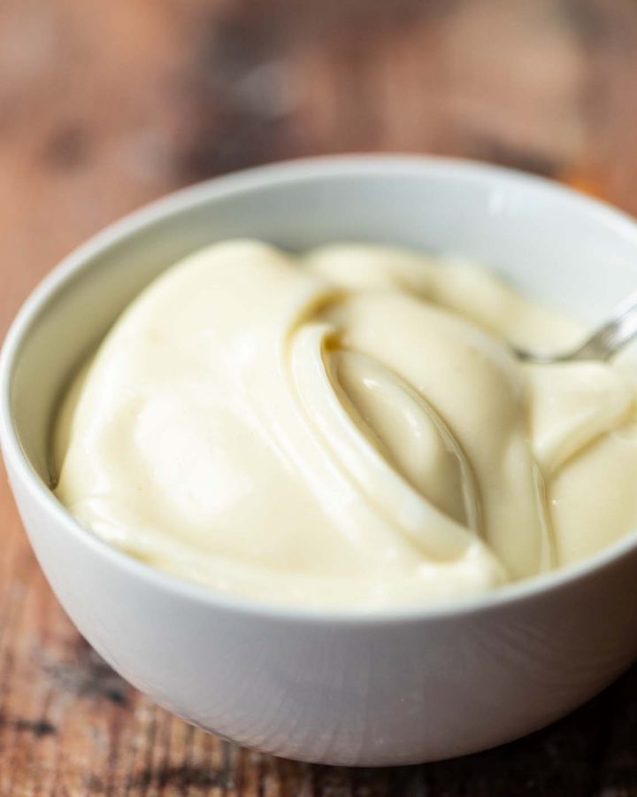 mayonnaise in small white bowl with teaspoon in