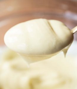 closeup shots of mayo on golden spoon