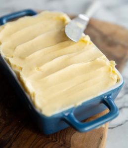butter in a small blue dish with knife resting on it