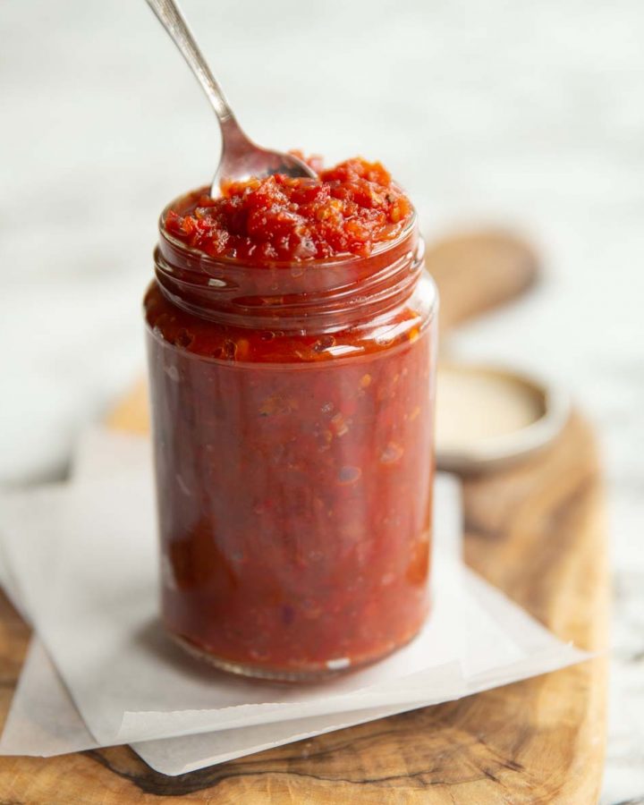 chutney in a clear jar with teaspoon popping out the top