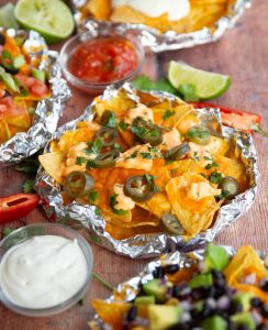 close up shot of foil packet nachos surrounded by garnish