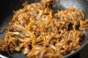 side shot of fully caramelized onions in a pan