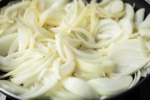 side shot of onions in a pan