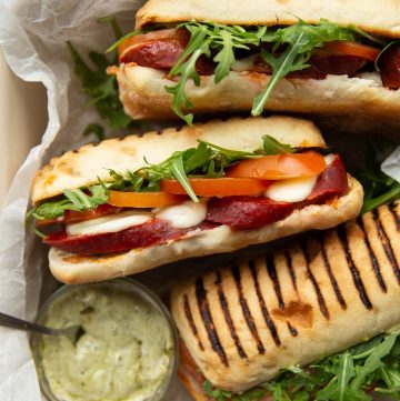 overhead shot of 3 sandwiches in dish with pesto mayo