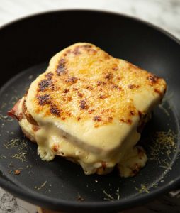 croque monsieur in a small pan fresh out the girll