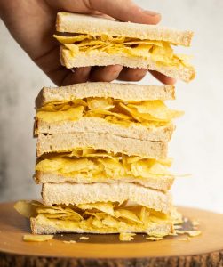 4 crisp sandwich halves stacked on each other with hand grabbing the top one