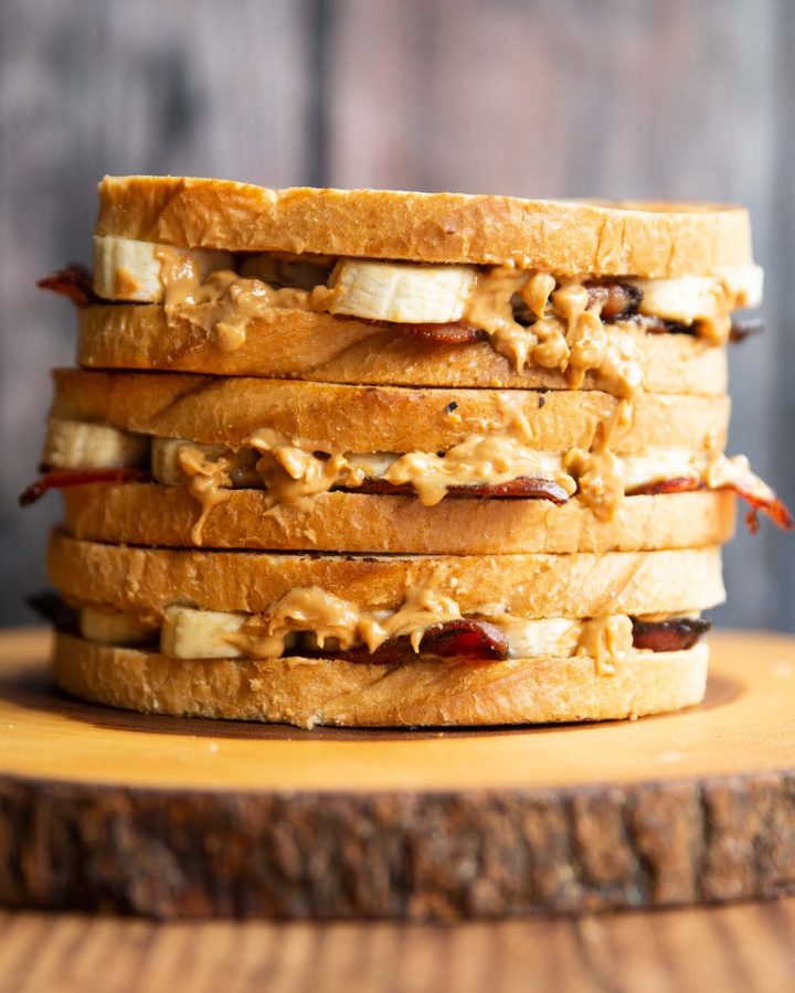 3 Elvis sandwiches stacked on each other on wooden board