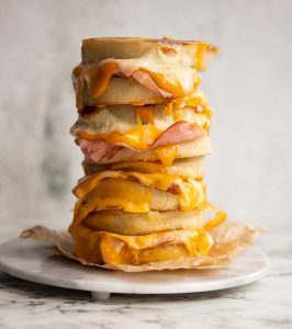 4 crumpet sandwiches stacked on each other on marble plate