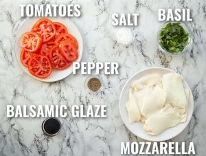 overhead shot of caprese salad ingredients with text labels