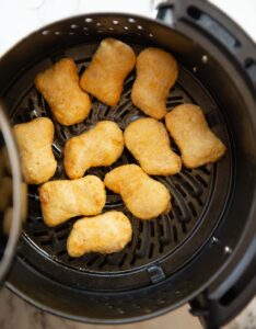 overhead shot of cooked chicken nuggets in the air fryer