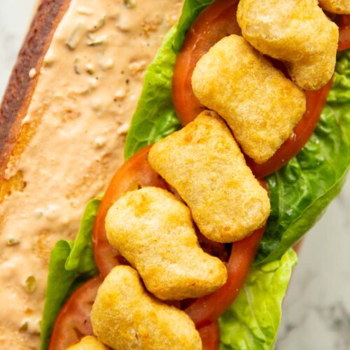 close up overhead shot of open chicken nugget sandwich showing filling