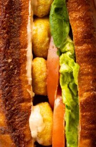 close up shot of chicken nugget sandwich showing filling
